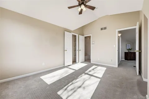 a view of a room with a ceiling fan