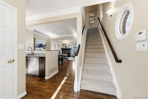 a view of entryway and hall with wooden floor