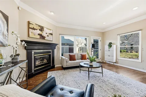 a living room with furniture a window and a fireplace