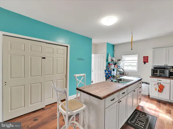 a kitchen that has a kitchen island wooden cabinets and stainless steel appliances