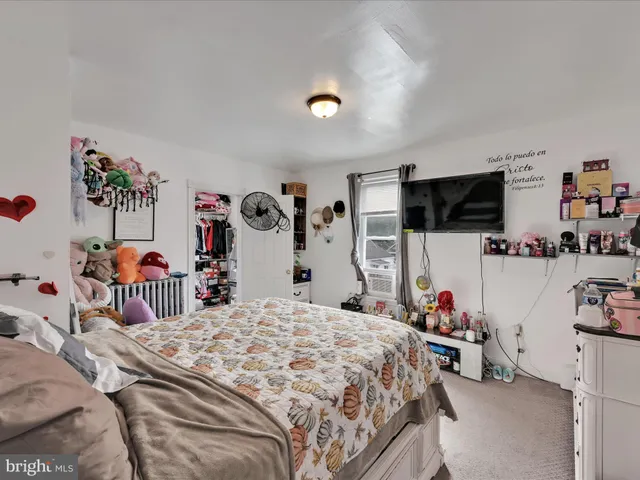 a bedroom with bed and a flat tv screen