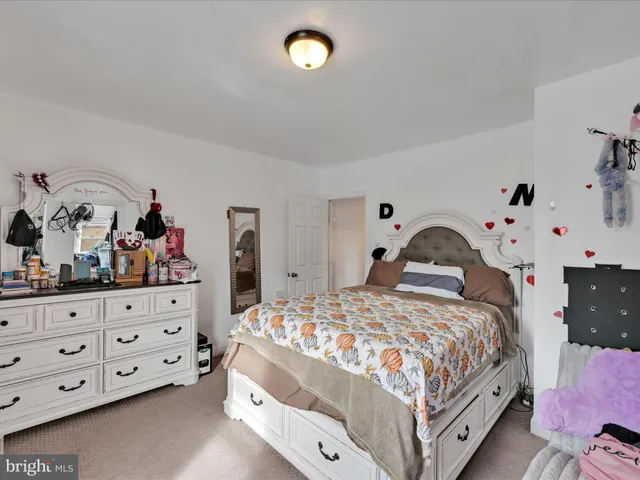 a bedroom with a bed and dresser
