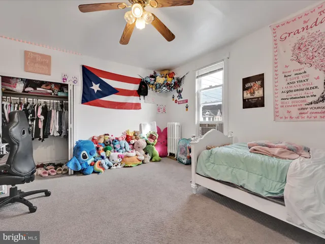 a bedroom with bed and a chandelier