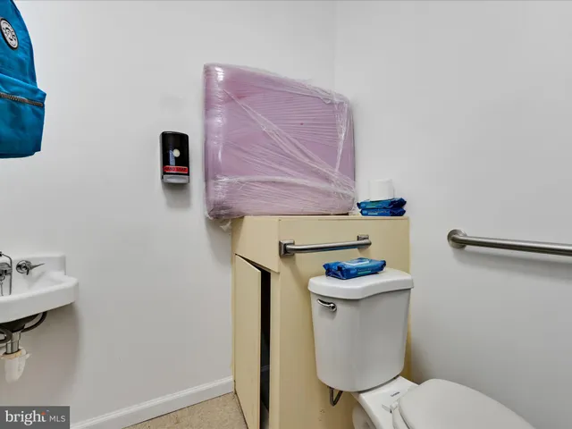a bathroom with a sink mirror and toilet