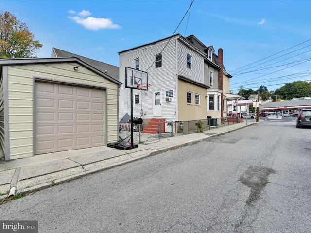 a view of a street with garage