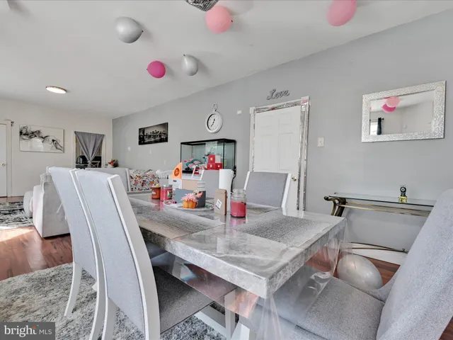 a dining room with furniture and a kitchen view