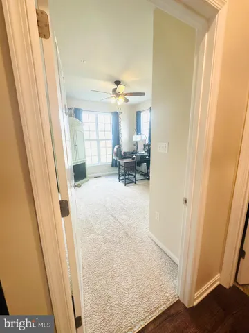 a view of a hallway with furniture and a window
