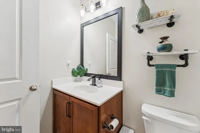 a bathroom with a sink toilet and mirror