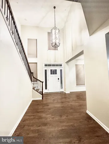 a living room with furniture a dining table a window and a chandelier