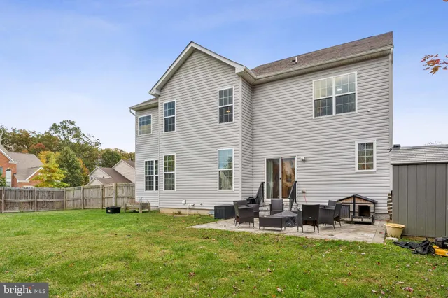a view of a house with a yard and sitting area
