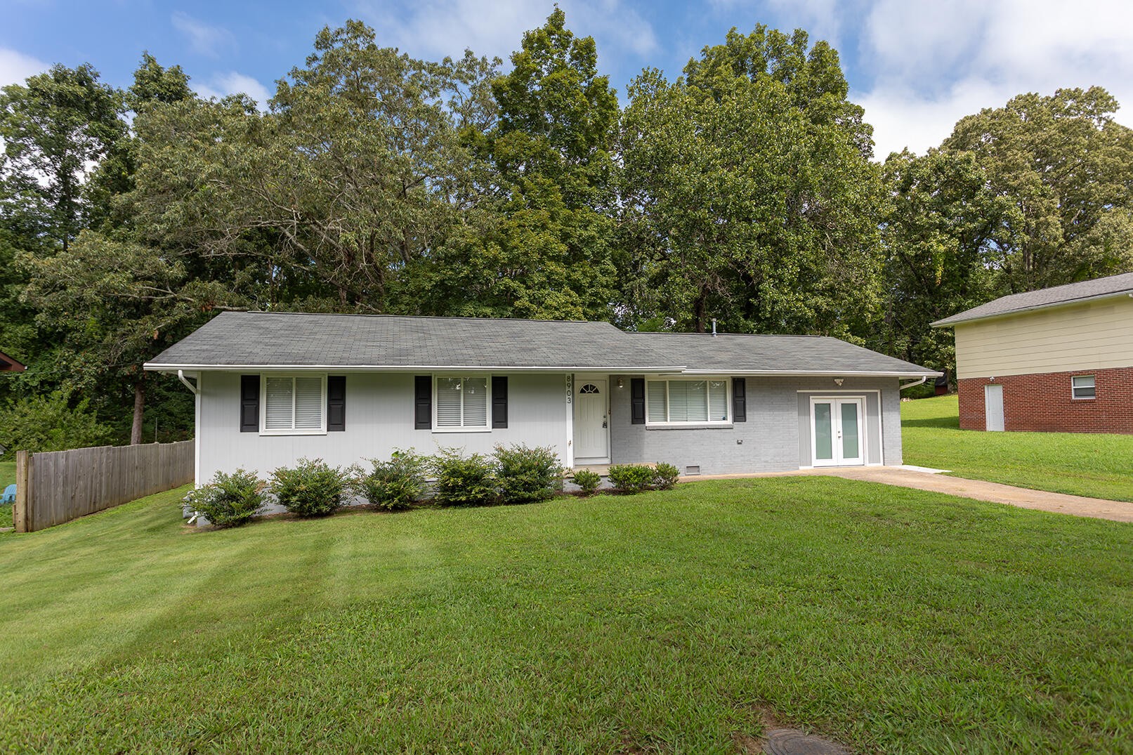 8903 Bay View Drive Chattanooga, TN 37416 - Photo 1 of 25 a front view of a house with a garden