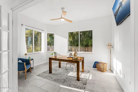a living room with furniture and a floor to ceiling window