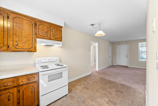 a view of a kitchen with stove and cabinets