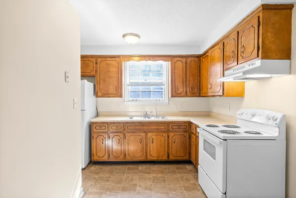 a kitchen with a sink stove and cabinets