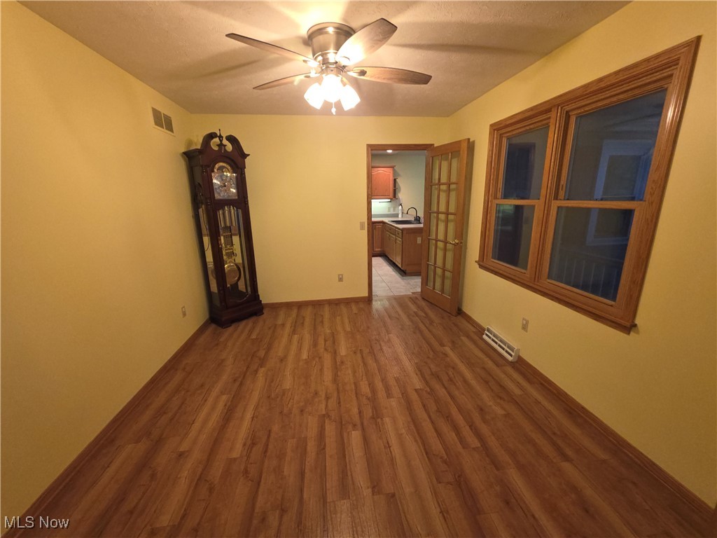 2291 Armstrong Road Wooster, OH 44691 - Photo 3 of 23 Dining room featuring vinyl finished floors, ceiling fan, and a textured ceiling