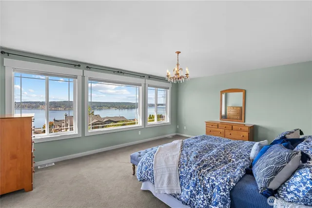 a bedroom with a large bed and a large window