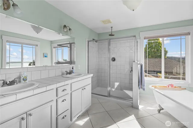a spacious bathroom with a shower sink and mirror