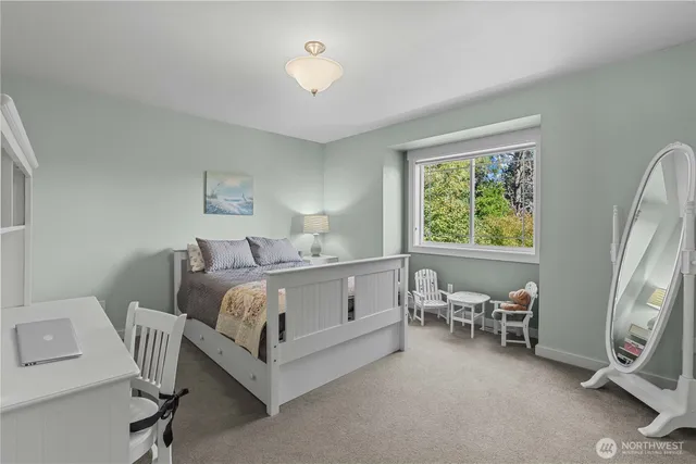 a bedroom with a bed chair and a window