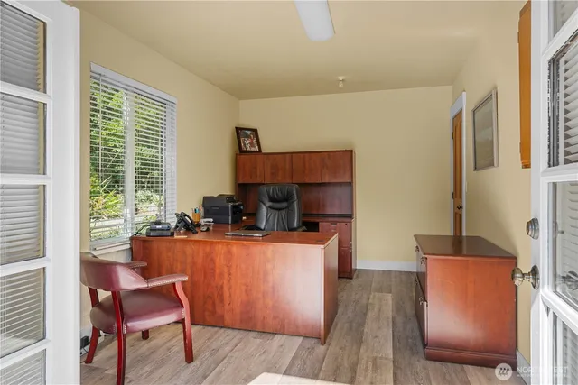 a room with furniture a large window and wooden floor