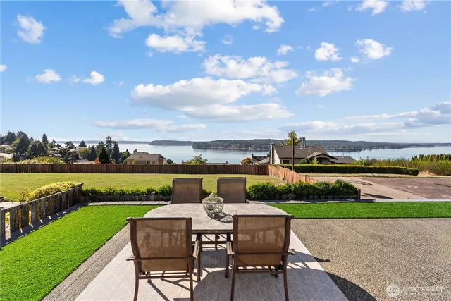 a view of a swimming pool with a patio and a garden