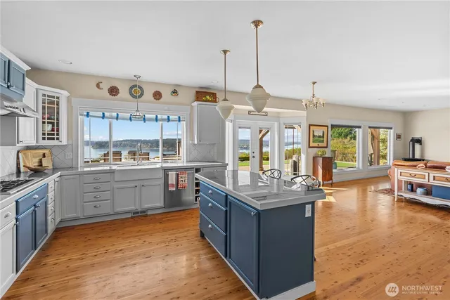a kitchen with stainless steel appliances granite countertop a sink and wooden cabinets