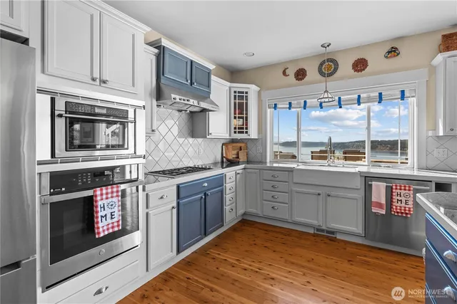 a kitchen with stainless steel appliances granite countertop a stove and cabinets