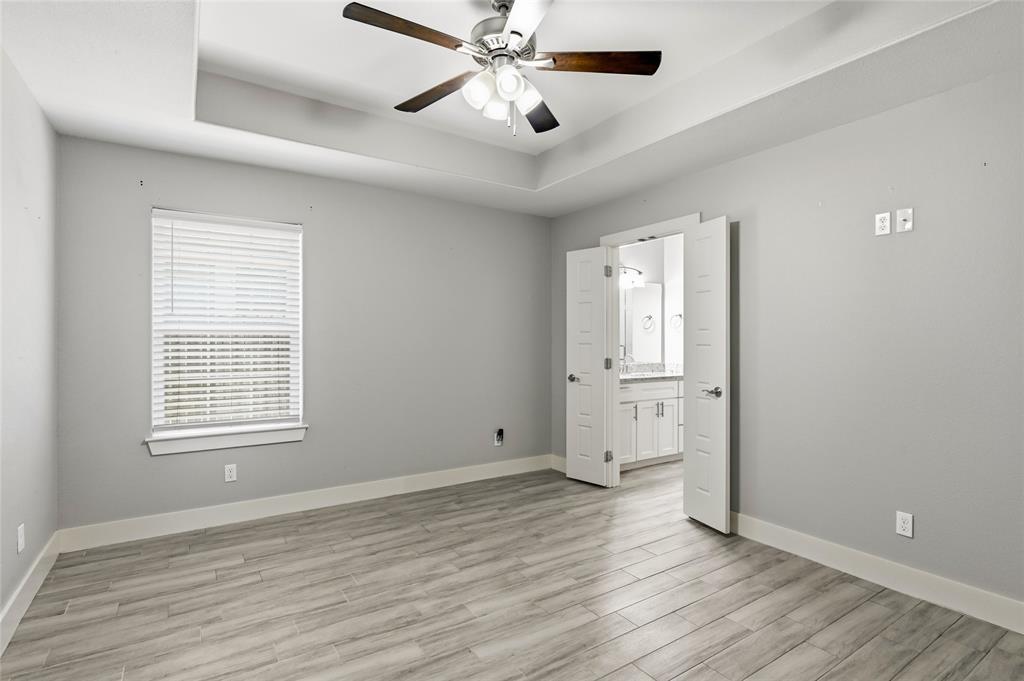 318 Munson Street Denison, TX 75021 - Photo 9 of 21 a view of an empty room with wooden floor and a window