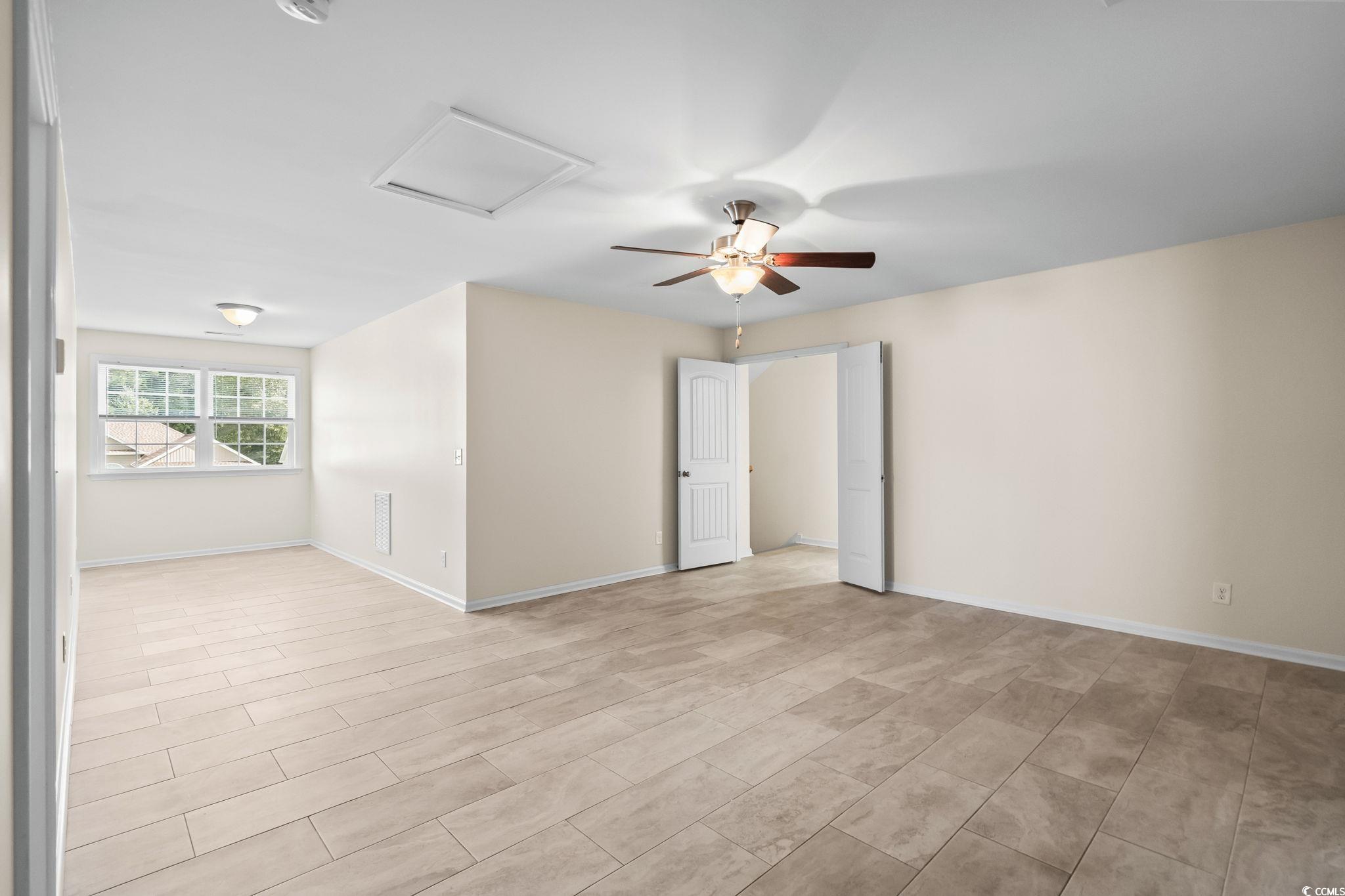 1050 Kennington Court Conway, SC 29526 - Photo 21 of 40 Spare room featuring attic access and a ceiling fan