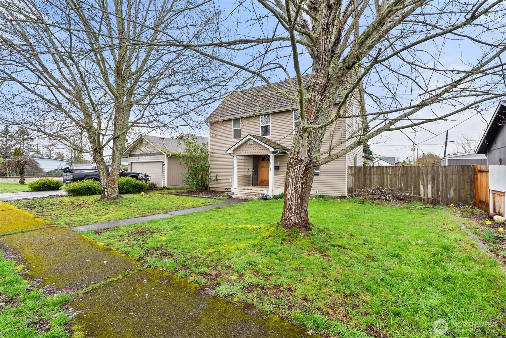 1024 H Street Centralia, WA 98531 - Photo 2 of 16 a white house that has a tree in front of a house