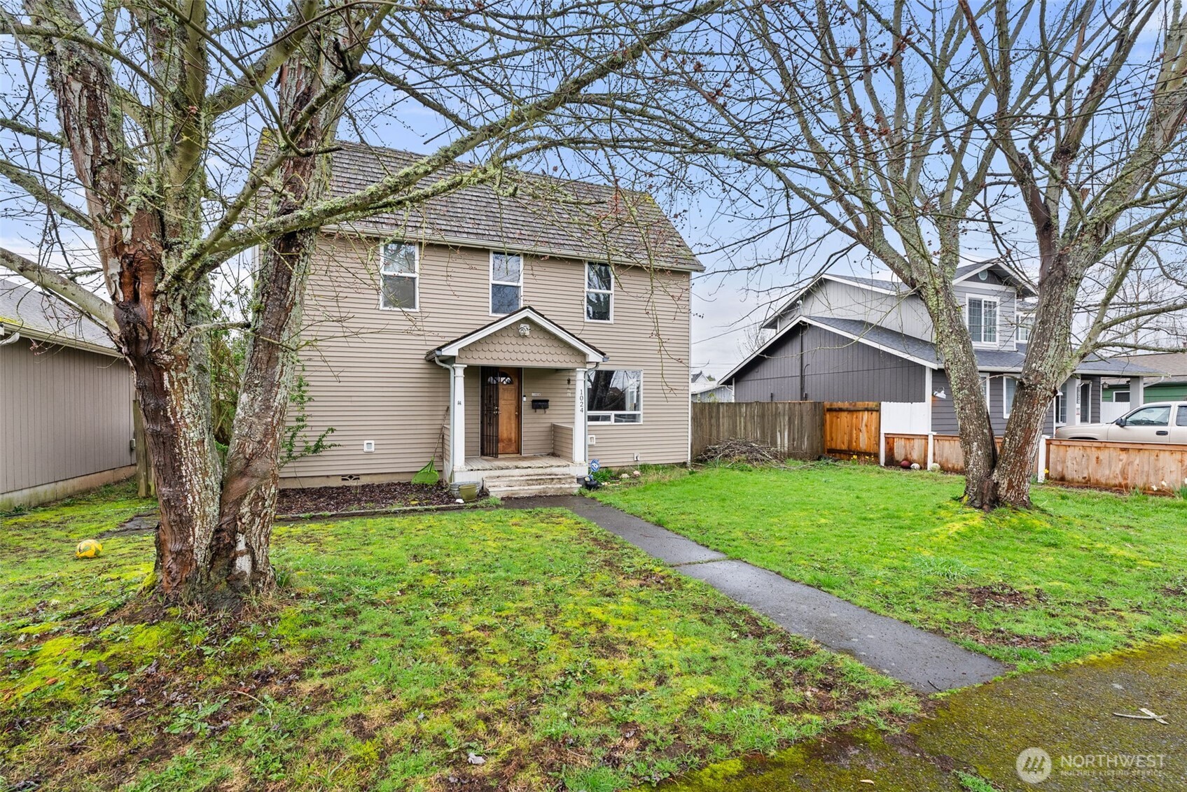 1024 H Street Centralia, WA 98531 - Photo 3 of 16 a front view of a house with a garden and trees