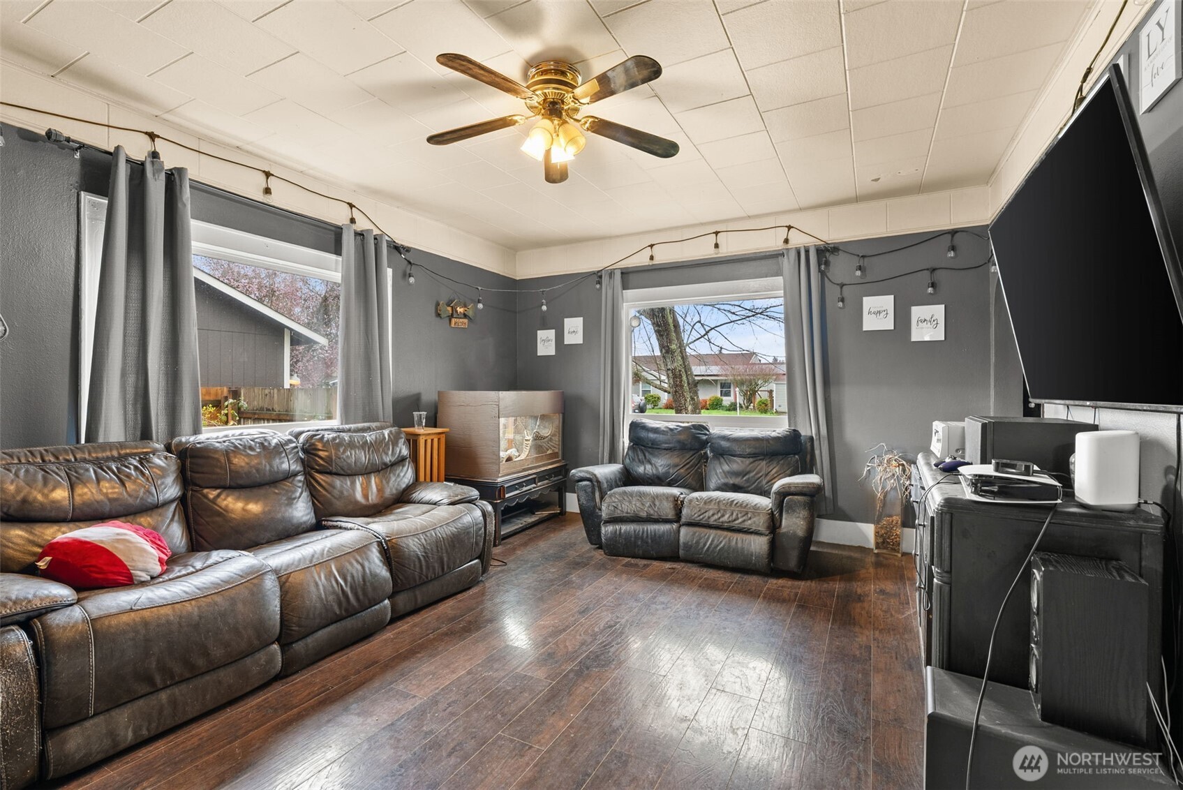 1024 H Street Centralia, WA 98531 - Photo 7 of 16 a living room with furniture a ceiling fan and a flat screen tv