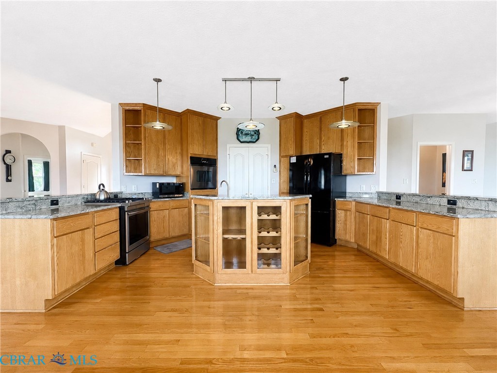 1214 Dandy Loop Road Yorktown, VA 23692 - Photo 21 of 65 a large kitchen with stainless steel appliances kitchen island granite countertop a stove a sink and a refrigerator