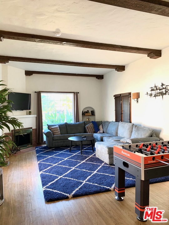 363 North Kings Road Los Angeles, CA 90048 - Photo 4 of 9 a living room with furniture and a flat screen tv