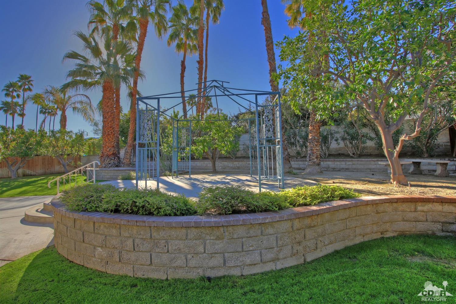 72957 Haystack Road Palm Desert, CA 92260 - Photo 11 of 38 front view of a house with a yard
