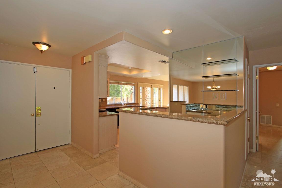 72957 Haystack Road Palm Desert, CA 92260 - Photo 23 of 38 a kitchen with stainless steel appliances granite countertop a sink and cabinets