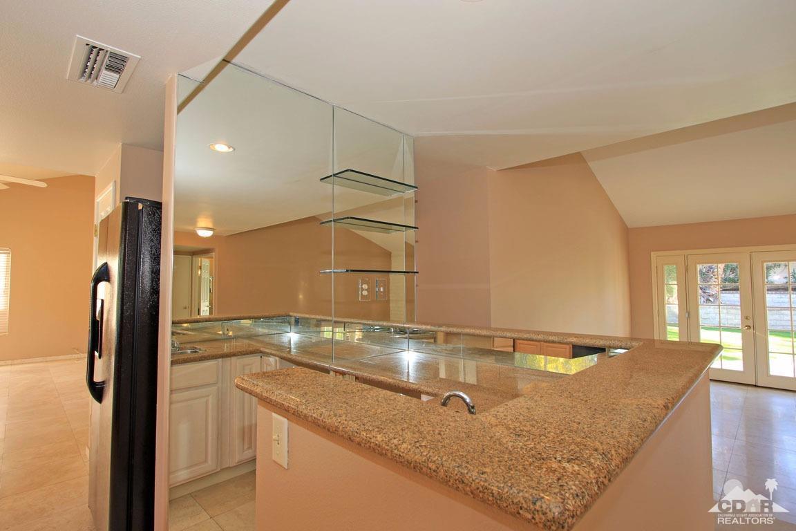 72957 Haystack Road Palm Desert, CA 92260 - Photo 24 of 38 a bathroom with a granite countertop sink and a large mirror