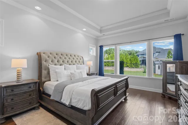 a bedroom with a bed and a dresser next to a window