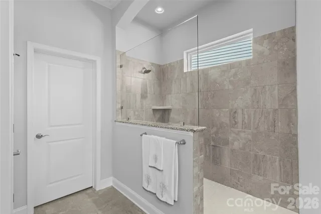 a bathroom with a shower and a sink