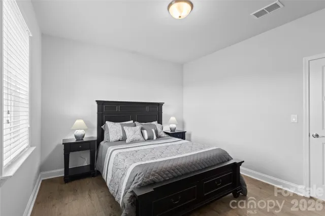 a bedroom with a bed and window