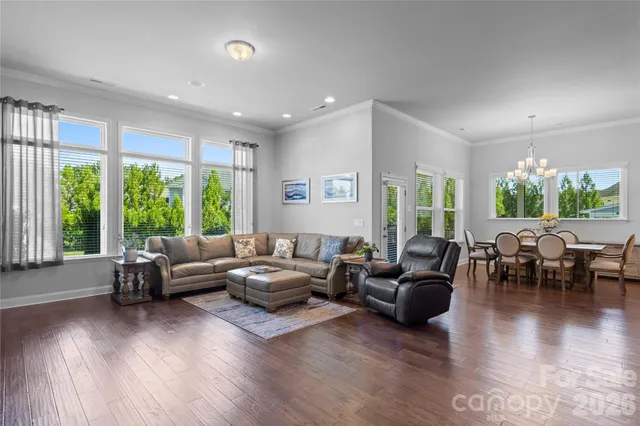 a living room with furniture and large windows