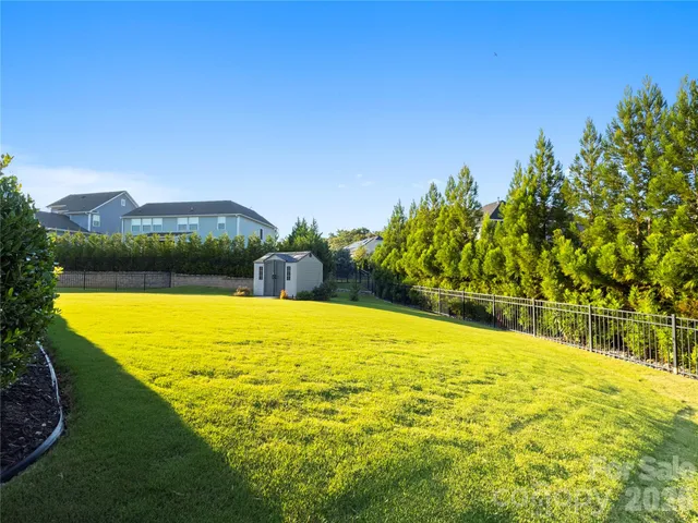 a view of a swimming pool with a yard