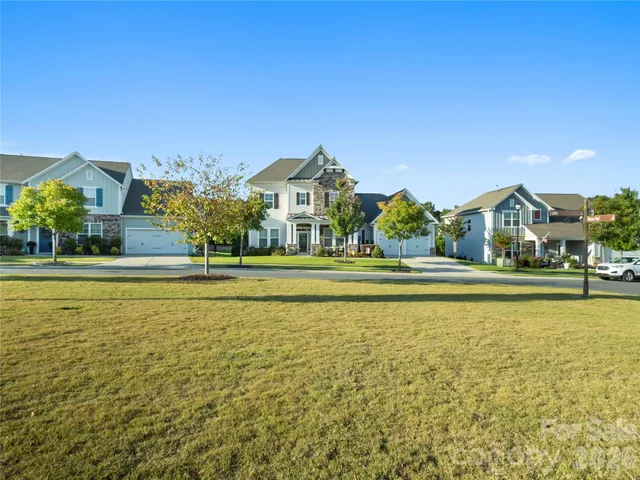a front view of a house with a big yard