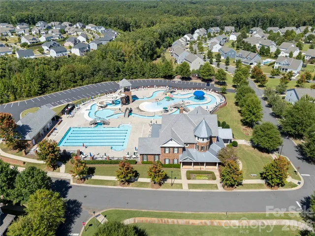 an aerial view of a house with a yard basket ball court and outdoor seating