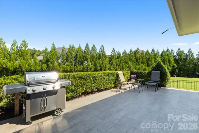 a view of a chairs and table in the back yard