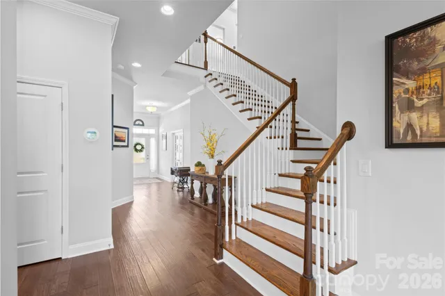 a view of entryway and hall with wooden floor