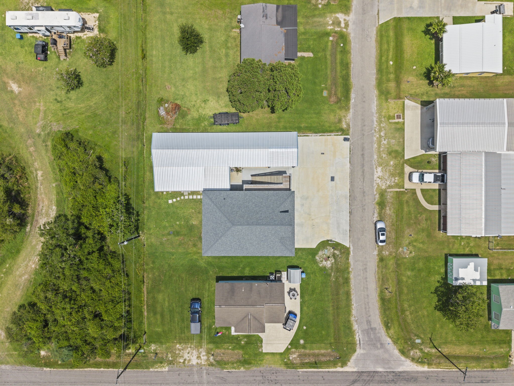 29 Rabbit Drive Port O'Connor, TX 77982 - Photo 21 of 21 This directly overhead aerial view outlines the complete footprint of the primary residence, attached garage/workshop structure, and surrounding lot space.