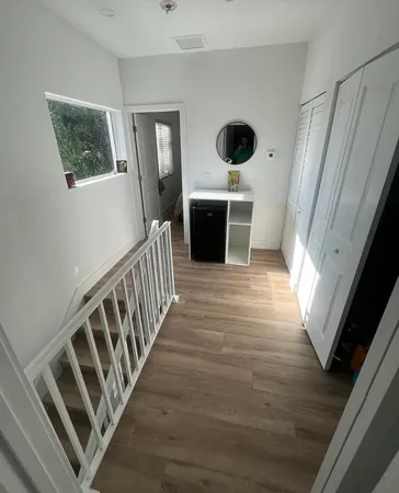a view of an entryway with wooden floor
