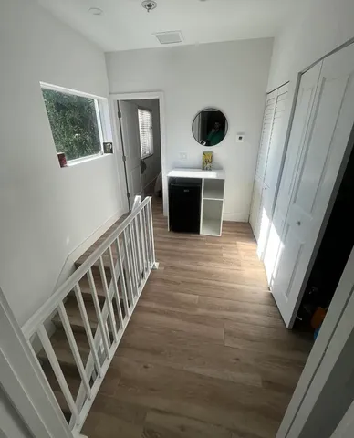 a view of an entryway with wooden floor