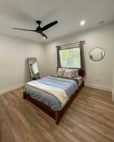 a bedroom with a bed and window