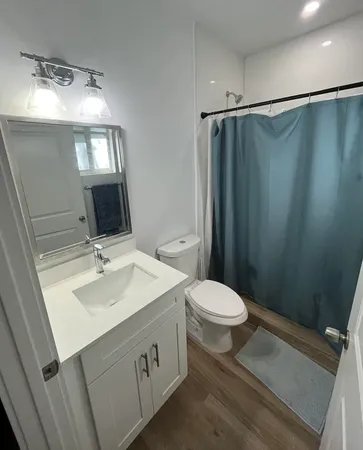 a bathroom with a sink toilet and mirror